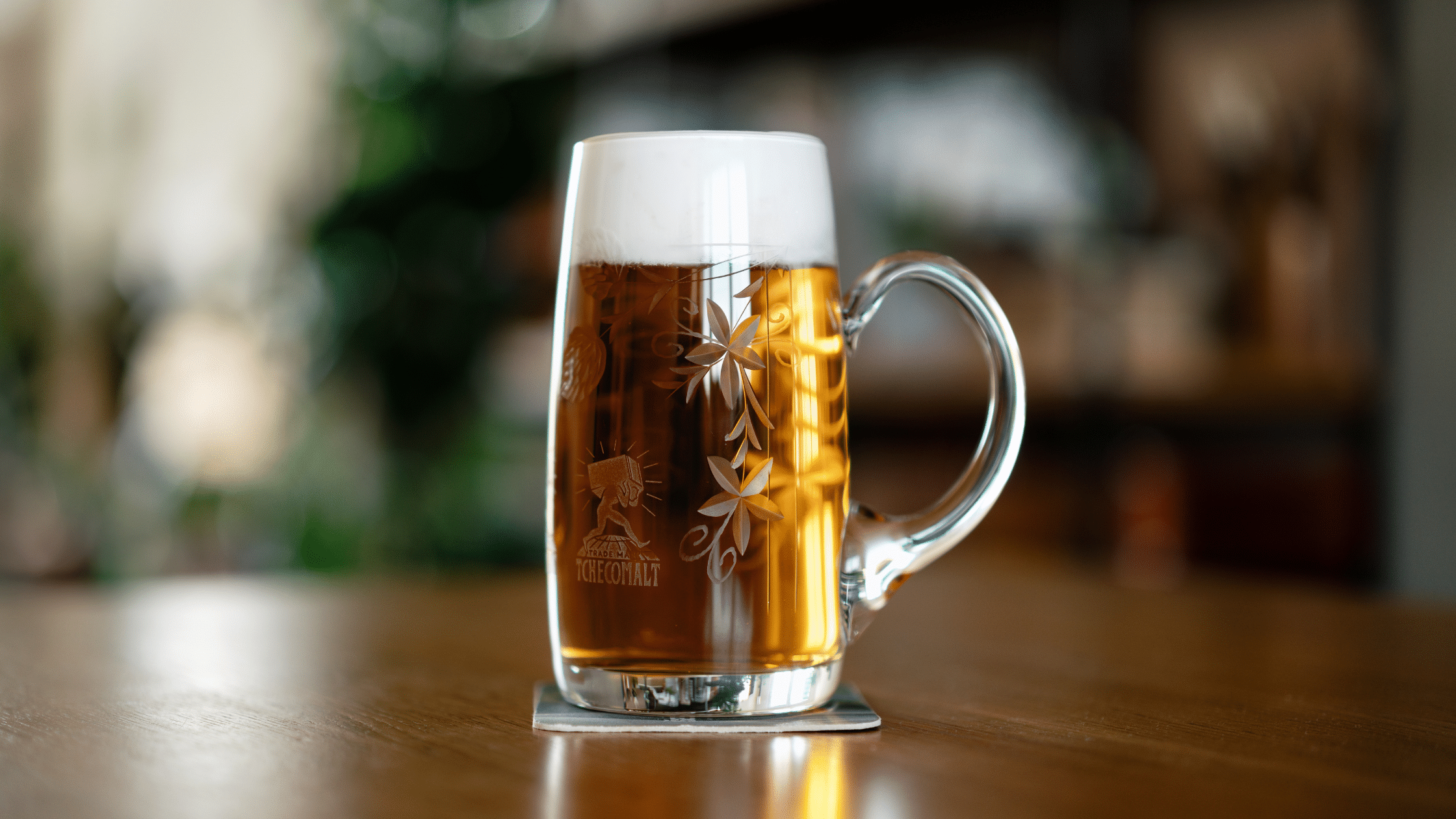 Czech lager beer in glass on a taproom bar featuring Tchecomalt